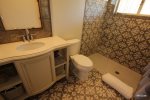 Bathroom with walk in shower that includes rain shower and handheld fixtures